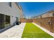 Large backyard featuring a patch of artificial turf, patio pavers, and access to a sliding glass door at 10429 Rose Palisade St, Las Vegas, NV 89141