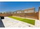 Clean backyard space with artificial turf, brick walls, and stone patio pavers; perfect for relaxation at 10429 Rose Palisade St, Las Vegas, NV 89141