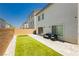 Cozy backyard featuring a small patch of artificial turf, patio pavers, and modern outdoor furniture at 10429 Rose Palisade St, Las Vegas, NV 89141