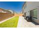 Cozy backyard featuring a small patch of artificial turf, patio pavers, and modern outdoor furniture at 10429 Rose Palisade St, Las Vegas, NV 89141