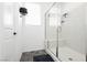 Modern bathroom features a walk-in shower with glass enclosure, tile flooring, and window at 10429 Rose Palisade St, Las Vegas, NV 89141