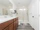 Bathroom featuring double vanity, walk-in shower with glass door, and gray flooring at 10429 Rose Palisade St, Las Vegas, NV 89141