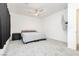 Minimalist bedroom showcasing neutral carpet, ceiling fan, and mounted television set at 10429 Rose Palisade St, Las Vegas, NV 89141
