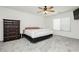 Bright bedroom featuring neutral walls, carpet flooring, and a ceiling fan at 10429 Rose Palisade St, Las Vegas, NV 89141