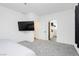 Large bedroom features carpet, and a large mounted television at 10429 Rose Palisade St, Las Vegas, NV 89141