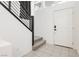 Bright entryway features tile floors, a staircase with modern railing, and a white front door at 10429 Rose Palisade St, Las Vegas, NV 89141