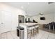Open-concept kitchen featuring center island, breakfast bar and stainless-steel appliances at 10429 Rose Palisade St, Las Vegas, NV 89141