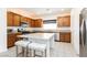 Beautiful kitchen featuring a large center island, granite countertops and stainless appliances at 10429 Rose Palisade St, Las Vegas, NV 89141