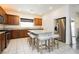 Well-lit kitchen features stainless steel appliances, a granite countertop, and a convenient island with stool seating at 10429 Rose Palisade St, Las Vegas, NV 89141