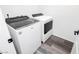 Laundry area featuring washer and dryer with gray wood-style flooring at 10429 Rose Palisade St, Las Vegas, NV 89141