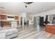 Open concept living room with sleek, modern flooring connecting to the kitchen at 10429 Rose Palisade St, Las Vegas, NV 89141