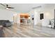 Open concept living room with sleek, modern flooring connecting to the kitchen at 10429 Rose Palisade St, Las Vegas, NV 89141