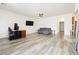 Spacious living room with sleek, modern flooring and neutral wall color at 10429 Rose Palisade St, Las Vegas, NV 89141
