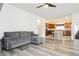 Inviting living room with wood floors, gray sofa, and an open layout to the kitchen at 10429 Rose Palisade St, Las Vegas, NV 89141