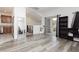 Open concept living room with sleek, modern flooring connecting to the kitchen at 10429 Rose Palisade St, Las Vegas, NV 89141