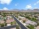 Expansive aerial view of a neighborhood with mountain views and single Gathering homes at 10645 Redwood Grove Ave, Las Vegas, NV 89144