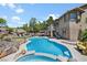 Lush backyard with a pool, spa, patio, outdoor kitchen, and landscaped gardens for ultimate relaxation at 10645 Redwood Grove Ave, Las Vegas, NV 89144
