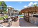 Inviting backyard features a covered patio, outdoor kitchen, dining area, and a sparkling swimming pool perfect for entertaining at 10645 Redwood Grove Ave, Las Vegas, NV 89144