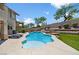 Inviting backyard featuring a pristine pool, patio, outdoor kitchen, and well manicured lawn at 10645 Redwood Grove Ave, Las Vegas, NV 89144