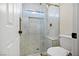 Bathroom showcasing a tiled shower with a glass door, built-in niche, and elegant fixtures at 10645 Redwood Grove Ave, Las Vegas, NV 89144