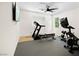 Bright exercise room equipped with a treadmill, stationary bike, and weightlifting equipment at 10645 Redwood Grove Ave, Las Vegas, NV 89144