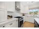 Well-lit kitchen featuring white cabinets, stainless steel appliances, and a sleek design at 10645 Redwood Grove Ave, Las Vegas, NV 89144