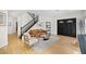 Comfortable living room with a tan sofa, unique glass coffee table, and staircase at 10645 Redwood Grove Ave, Las Vegas, NV 89144