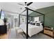 Serene main bedroom featuring a four-poster bed, stylish rug, and neutral tones at 10645 Redwood Grove Ave, Las Vegas, NV 89144