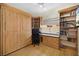 Multi-purpose room featuring built-in shelving, a desk area, and a stylish Murphy bed for guests at 10645 Redwood Grove Ave, Las Vegas, NV 89144