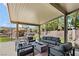 Inviting outdoor space with stylish seating, fire pit, and a tiki bar, ideal for relaxation and entertaining guests at 10645 Redwood Grove Ave, Las Vegas, NV 89144