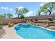 Serene backyard featuring a pristine pool, spa, and lush landscaping for a tranquil escape at 10645 Redwood Grove Ave, Las Vegas, NV 89144