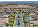 Aerial view of a residential area showcasing homes, landscaping, community parks, and swimming pools at 10656 Hyde Corner Ave, Las Vegas, NV 89166