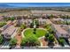 Aerial view of a neighborhood featuring a heart-shaped park with lush trees and well-maintained homes at 10656 Hyde Corner Ave, Las Vegas, NV 89166