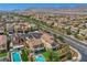 Aerial view of homes, pools, and desert landscape, offering a perspective of the neighborhood layout at 10656 Hyde Corner Ave, Las Vegas, NV 89166