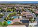 Stunning aerial view of a home with a pool, hot tub, solar panels, and beautifully landscaped backyard in a vibrant community at 10656 Hyde Corner Ave, Las Vegas, NV 89166