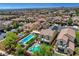 Overhead view of a backyard with a pool and spa, set against the backdrop of a vibrant neighborhood at 10656 Hyde Corner Ave, Las Vegas, NV 89166