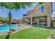 Expansive backyard with a pool, covered patio, and upper balcony at 10656 Hyde Corner Ave, Las Vegas, NV 89166