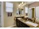 Bright bathroom with double sinks, granite counters and decorative accents create a charming, inviting space at 10656 Hyde Corner Ave, Las Vegas, NV 89166