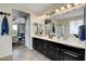 Bright bathroom with double sinks, dark cabinets, and a separate shower at 10656 Hyde Corner Ave, Las Vegas, NV 89166