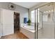 Bathroom featuring a soaking tub, glass shower and walk-in closet at 10656 Hyde Corner Ave, Las Vegas, NV 89166