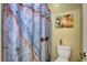 Cozy bathroom featuring a unique barn door-style shower curtain and a colorful cow-themed wall art at 10656 Hyde Corner Ave, Las Vegas, NV 89166