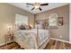 Bedroom featuring wood floors, ceiling fan, a mirror and neutral paint at 10656 Hyde Corner Ave, Las Vegas, NV 89166