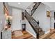 Welcoming entryway featuring wood floors, a staircase, and tasteful decor at 10656 Hyde Corner Ave, Las Vegas, NV 89166