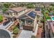 Attractive home featuring solar panels, a two-car garage, and a well-maintained front yard with mature trees and shrubbery at 10656 Hyde Corner Ave, Las Vegas, NV 89166