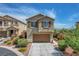 Charming two-story home featuring a two-car garage, neutral stucco, and tidy landscaping at 10656 Hyde Corner Ave, Las Vegas, NV 89166