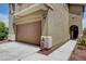 Two-car garage with an automatic door, exterior light fixture, and front yard at 10656 Hyde Corner Ave, Las Vegas, NV 89166