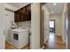 Spacious laundry room with modern appliances, storage cabinets, and convenient access to other areas of the home at 10656 Hyde Corner Ave, Las Vegas, NV 89166