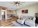 Comfortable living room featuring a plush sectional, ceiling fan, and stylish decor at 10656 Hyde Corner Ave, Las Vegas, NV 89166