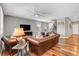 This spacious living room has a ceiling fan, hardwood floors and staircase at 10656 Hyde Corner Ave, Las Vegas, NV 89166