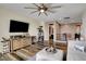 Spacious living room with a large TV, comfortable seating, and modern decor at 10656 Hyde Corner Ave, Las Vegas, NV 89166